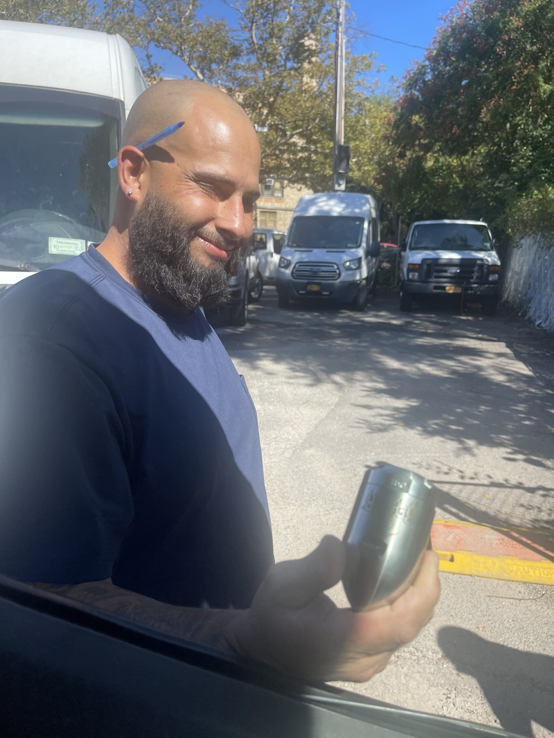 Man smiling while holding the metal equipment